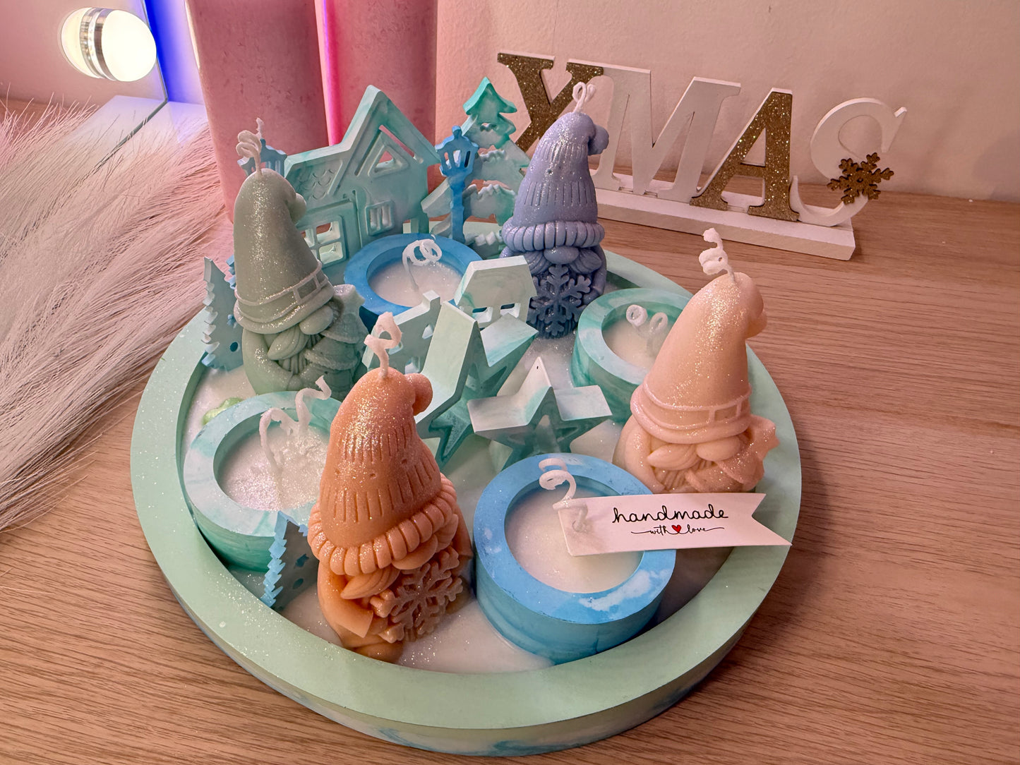 Wichtel-Dekoarrangement in Grüntönen, handgegossene Kerzenfiguren mit Winterhäusern und Tannen, handmade Design.